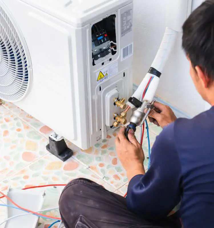 Home air conditioning in Bristol Engineer connecting refrigerant pipework to a home air conditioning outdoor unit in Bristol